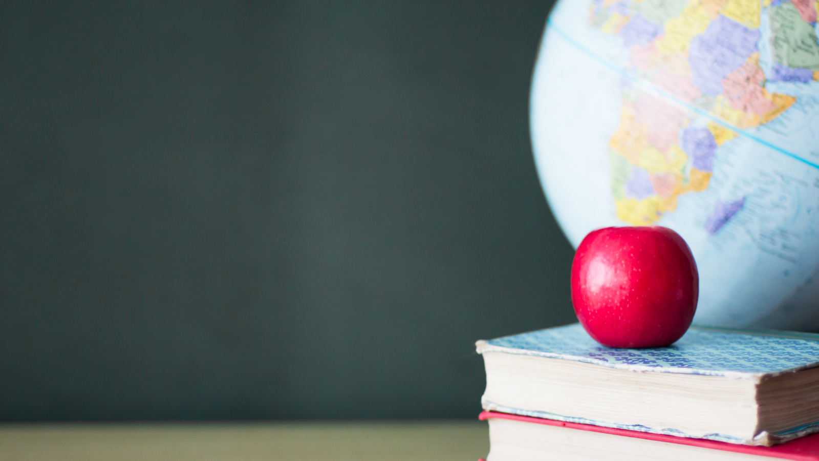 Image showing Globe, red apple and books
